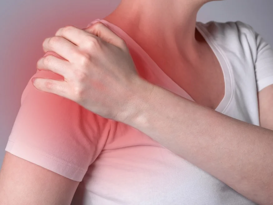Woman holding painful frozen shoulder